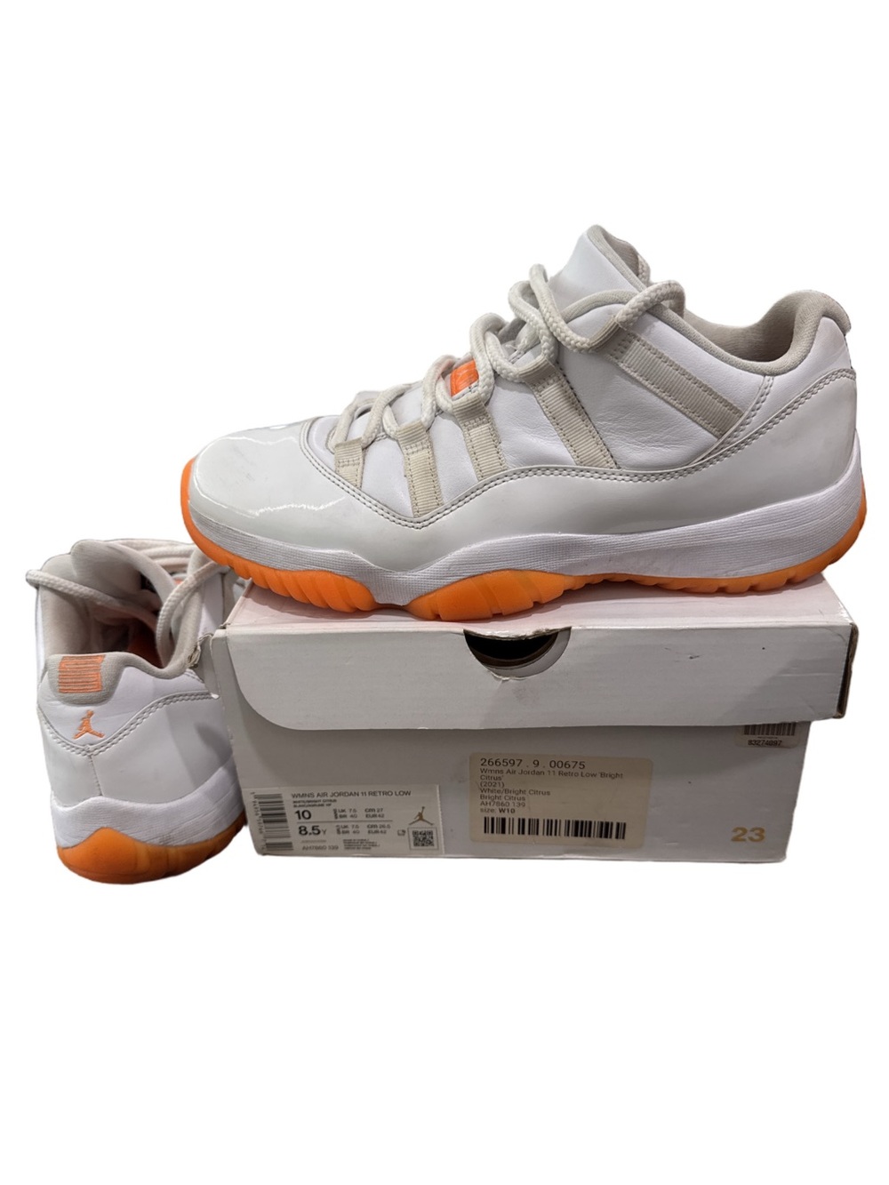 Jordan Woman's Air Jordan 11 Retro White and Orange Low Top Athletic Sneakers